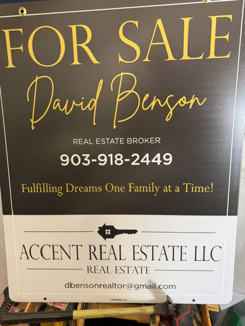 An Accent Real Estate For Sale sign naming David Benson as broker
